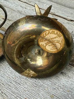 Vintage brass candleholder with a label 